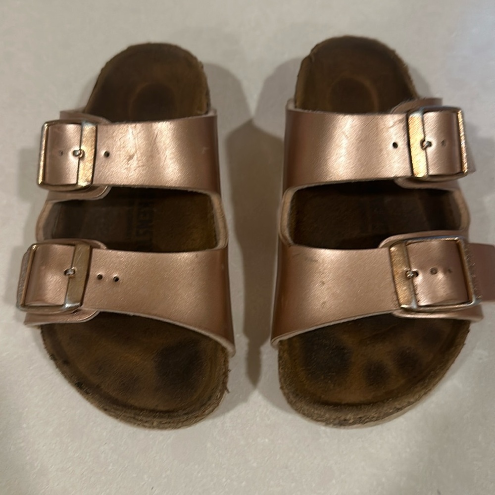 Well worn kids Birkenstock size 8 (26). Rose gold color.